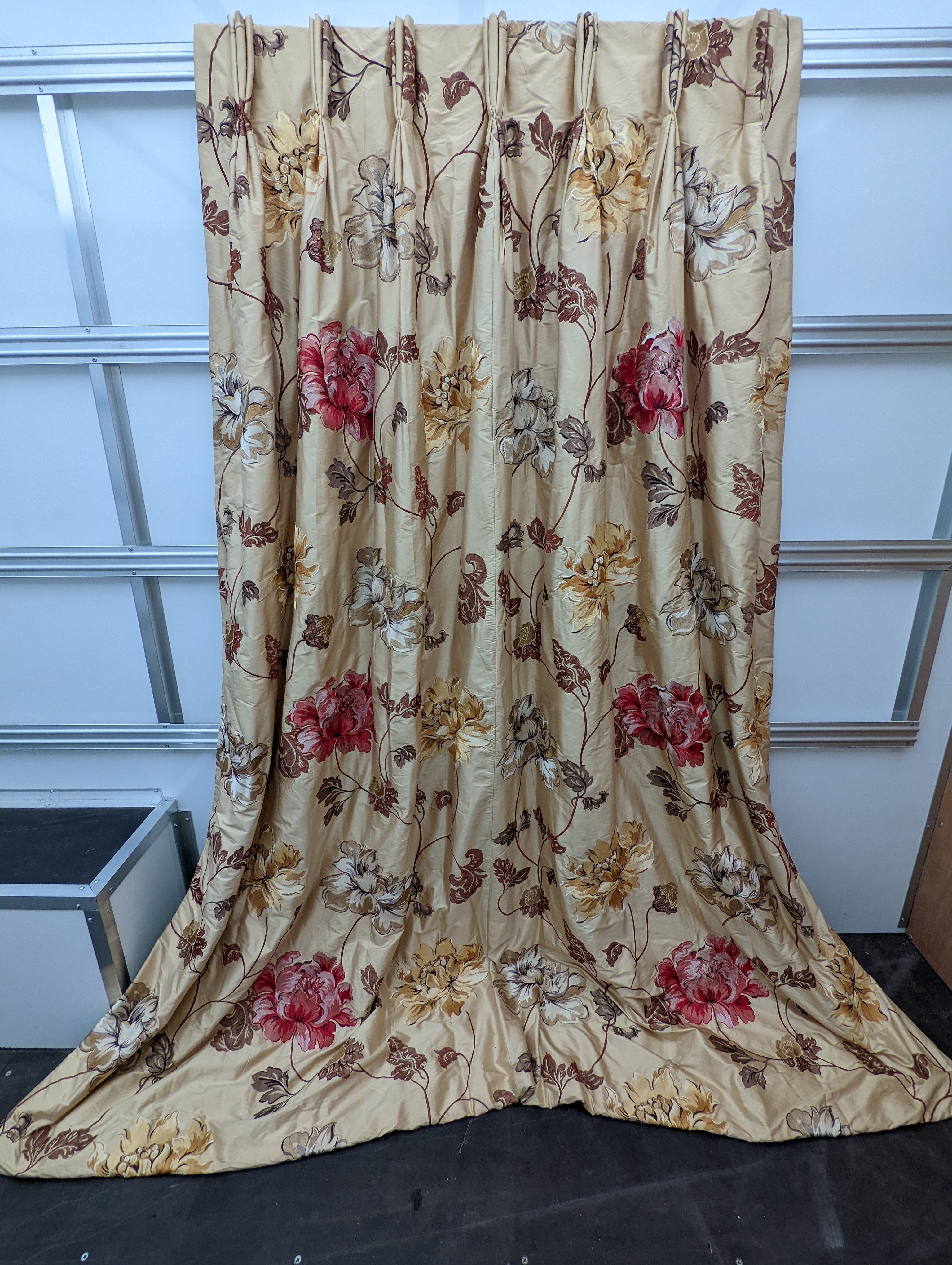 A pair of floral lined curtains. Approximate measurements: Width of top 110cm, Width of bottom 220cm Length 250cm